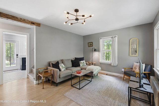 766 County Route 2, Accord, NY 12404 - living room featuring plenty of natural light, a chandelier, light wood-type flooring, and baseboards