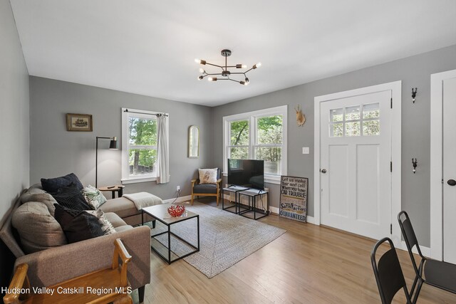 766 County Route 2, Accord, NY 12404 - living area with light wood finished floors, a chandelier, and baseboards