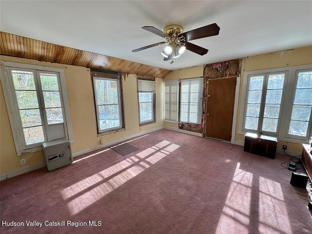 interior space with lofted ceiling, wooden ceiling, and ceiling fan