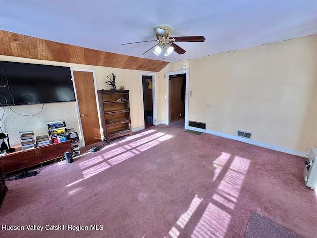 unfurnished bedroom featuring ceiling fan, lofted ceiling, and carpet flooring