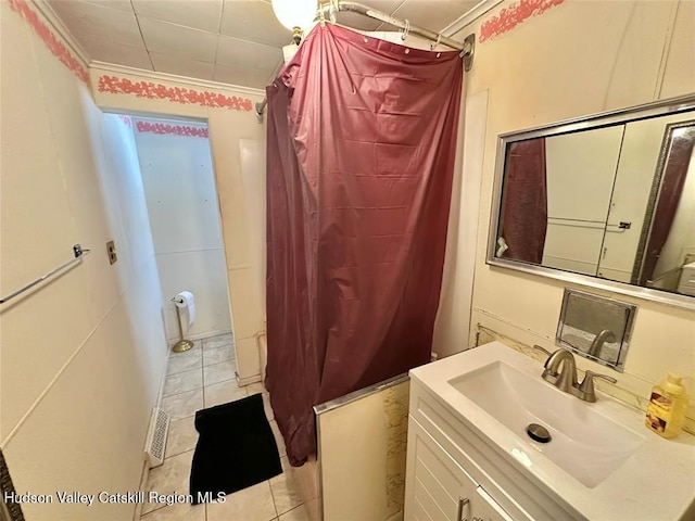 bathroom with ornamental molding, tile patterned floors, and vanity