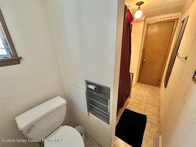 bathroom with toilet and tile patterned flooring