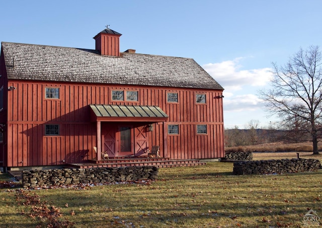 23 Raccoon Forks Rd, Old Chatham, NY 12136 - rear view of house with a chimney, a yard, and board and batten siding