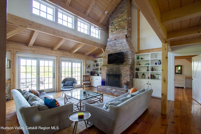 23 Raccoon Forks Rd, Old Chatham, NY 12136 - living area with wood ceiling, beam ceiling, wood-type flooring, plenty of natural light, and a brick fireplace