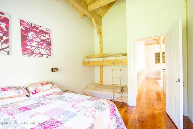 23 Raccoon Forks Rd, Old Chatham, NY 12136 - bedroom with wood-type flooring, beamed ceiling, and high vaulted ceiling