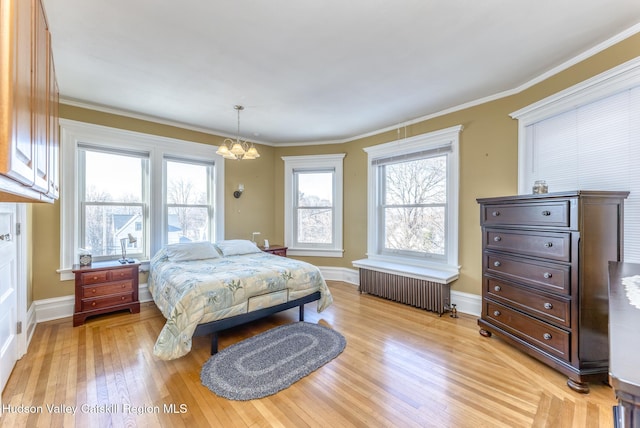 bedroom with radiator, crown molding, a notable chandelier, and light wood-type flooring