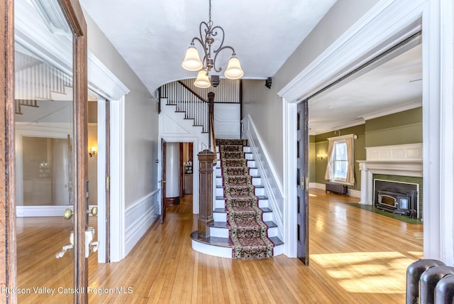 foyer entrance featuring ornamental molding and light hardwood / wood-style flooring