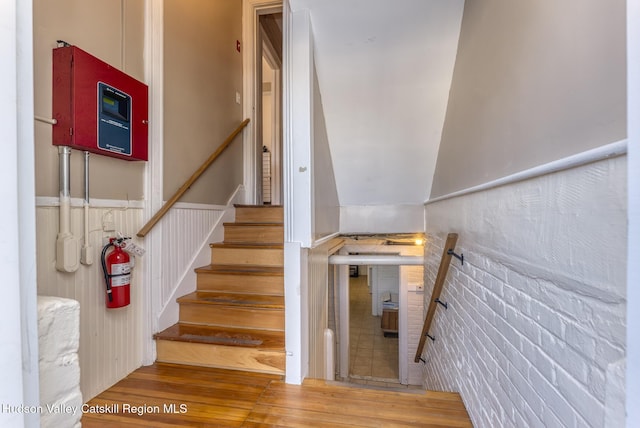 staircase with hardwood / wood-style floors