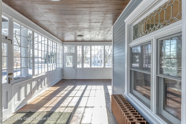 unfurnished sunroom featuring wooden ceiling