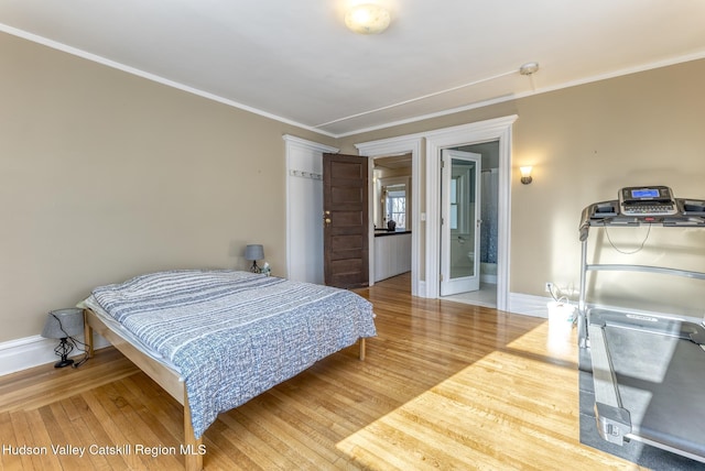 bedroom featuring crown molding and hardwood / wood-style flooring