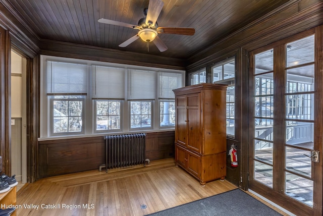 interior space with radiator heating unit, wooden ceiling, and ceiling fan