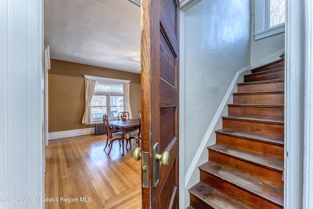 stairs featuring hardwood / wood-style floors