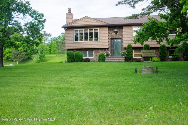 526 Taghkanic Rd, Elizaville, NY 12523 - split foyer home with a chimney, a front lawn, and brick siding