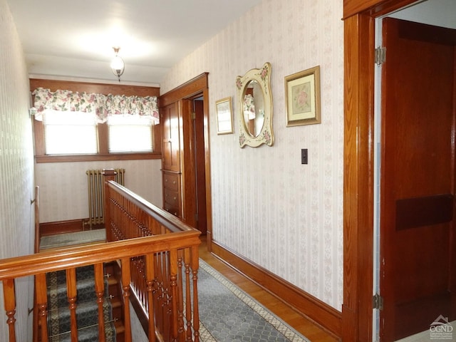 19 Aitken Ave, Hudson, NY 12534 - hall with radiator heating unit, wallpapered walls, wood finished floors, an upstairs landing, and baseboards