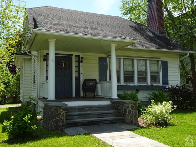 19 Aitken Ave, Hudson, NY 12534 - bungalow-style home with covered porch, a chimney, and roof with shingles