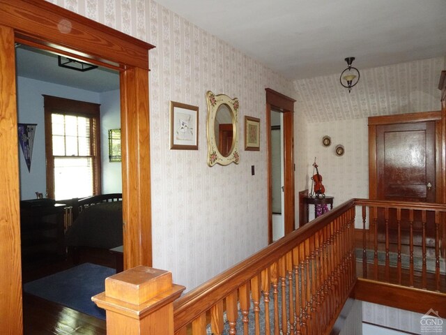 19 Aitken Ave, Hudson, NY 12534 - hall featuring wallpapered walls, wood finished floors, and an upstairs landing
