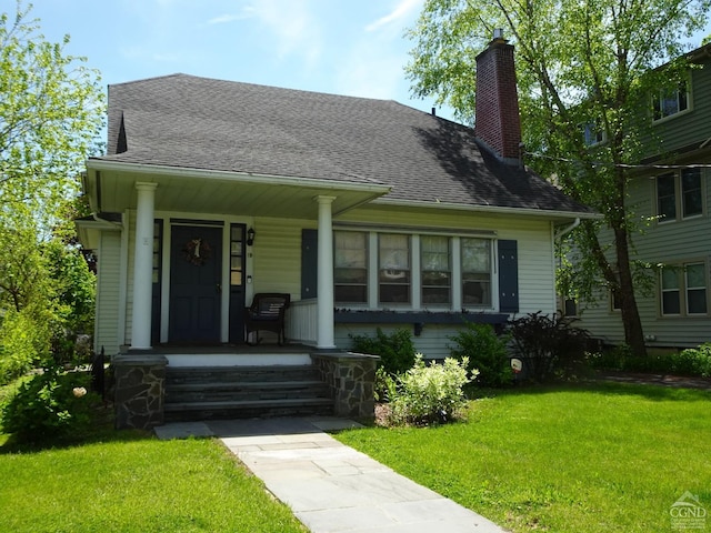 19 Aitken Ave, Hudson, NY 12534 - bungalow-style house with a porch, a front yard, a chimney, and roof with shingles