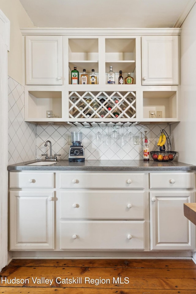 272 Main St, Middleburgh, NY 12122 - indoor wet bar featuring backsplash and wood finished floors