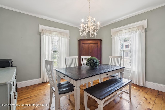 272 Main St, Middleburgh, NY 12122 - dining room featuring healthy amount of natural light, a chandelier, crown molding, and light wood-style floors