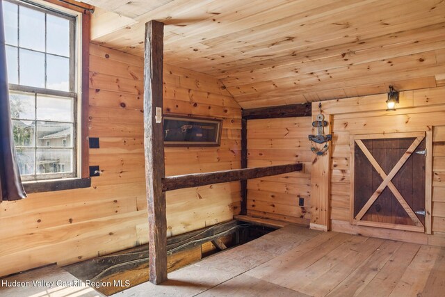 272 Main St, Middleburgh, NY 12122 - interior space featuring healthy amount of natural light, vaulted ceiling, wooden walls, hardwood / wood-style flooring, and wooden ceiling