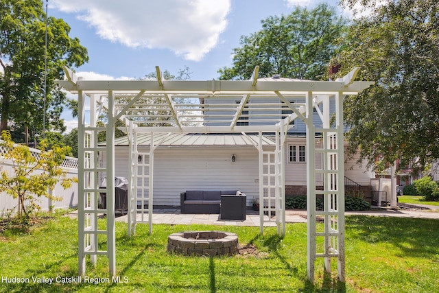 272 Main St, Middleburgh, NY 12122 - back of house with a patio area, an outdoor living space with a fire pit, a pergola, and a standing seam roof