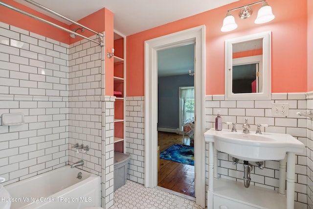 272 Main St, Middleburgh, NY 12122 - full bathroom with baseboard heating, tub / shower combination, tile walls, wainscoting, and tile patterned floors