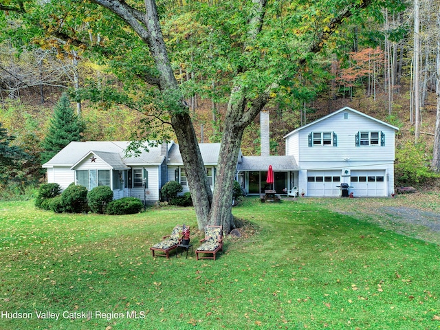 view of front of home with a front lawn and a garage