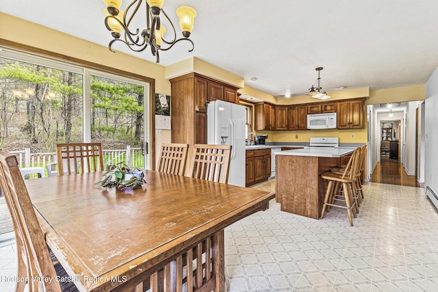 dining area with light wood-type flooring, sink, and a chandelier