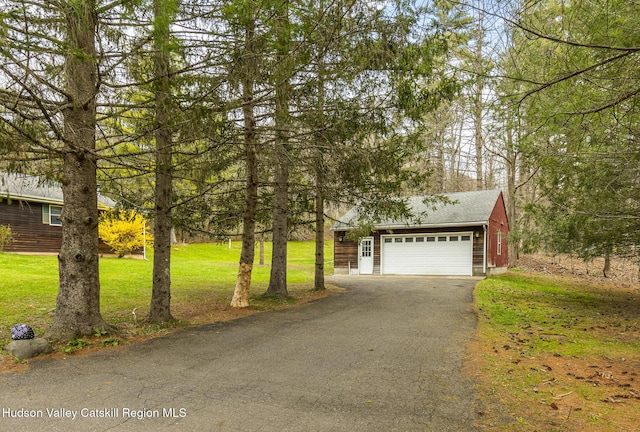 view of front of house with a garage and a front yard