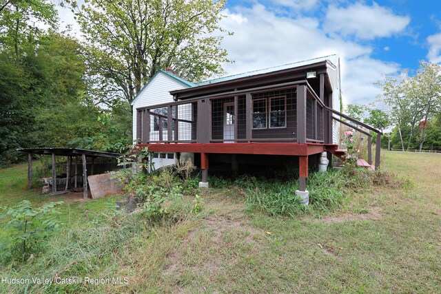 rear view of property with a lawn