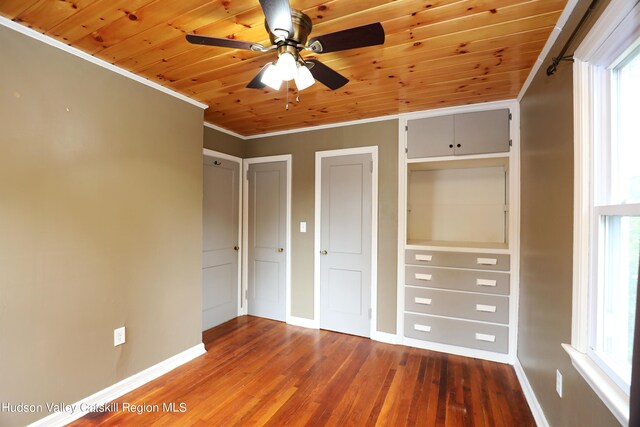 unfurnished bedroom with hardwood / wood-style floors, wooden ceiling, and multiple windows