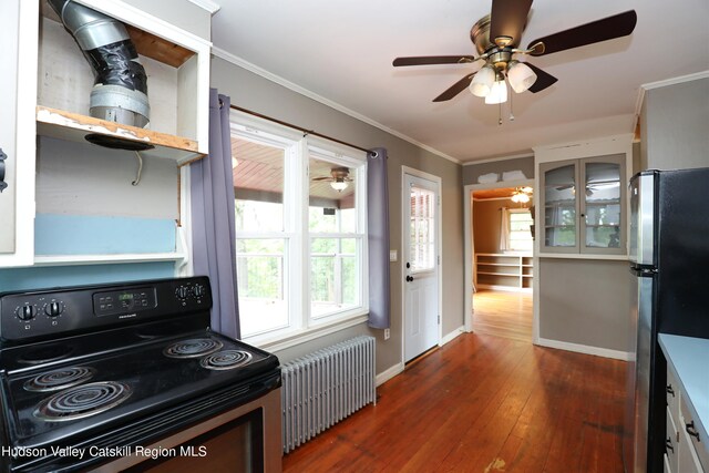 kitchen featuring stainless steel fridge, dark hardwood / wood-style flooring, crown molding, black electric range, and radiator heating unit