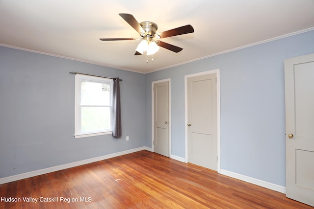 unfurnished bedroom featuring ceiling fan, light hardwood / wood-style floors, and ornamental molding