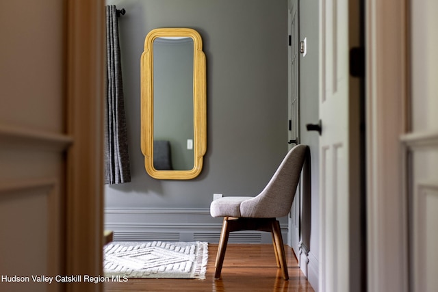 details with a wainscoted wall and wood finished floors