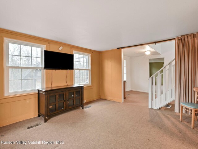 living room featuring carpet flooring and ornamental molding