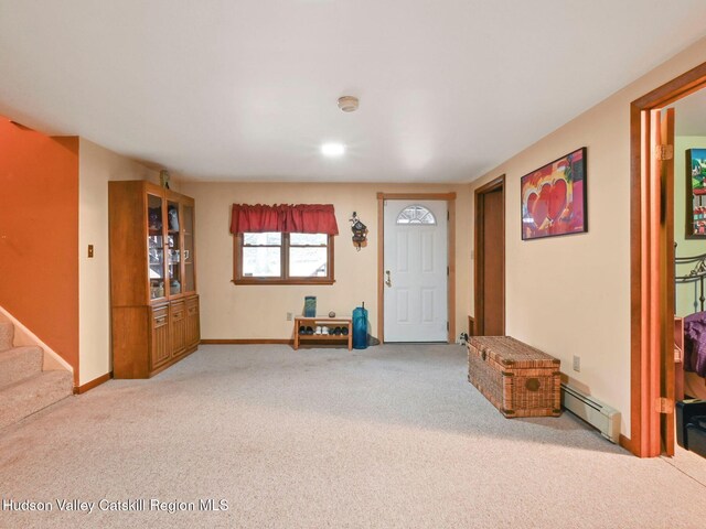 carpeted foyer entrance featuring a baseboard heating unit