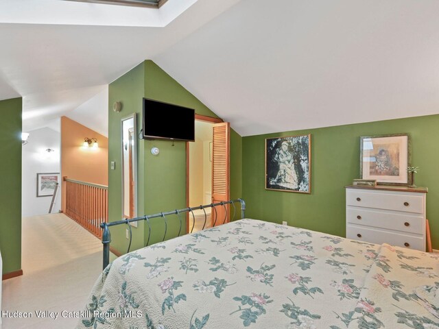 bedroom featuring lofted ceiling with skylight