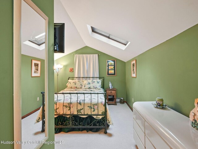 carpeted bedroom with lofted ceiling with skylight