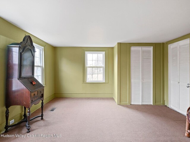 interior space featuring light colored carpet