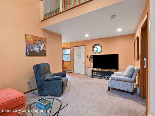 carpeted living room with baseboard heating