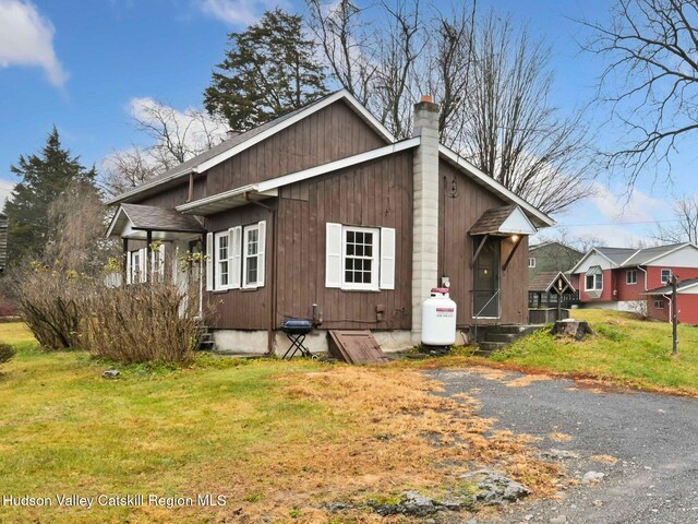 view of side of property with a lawn