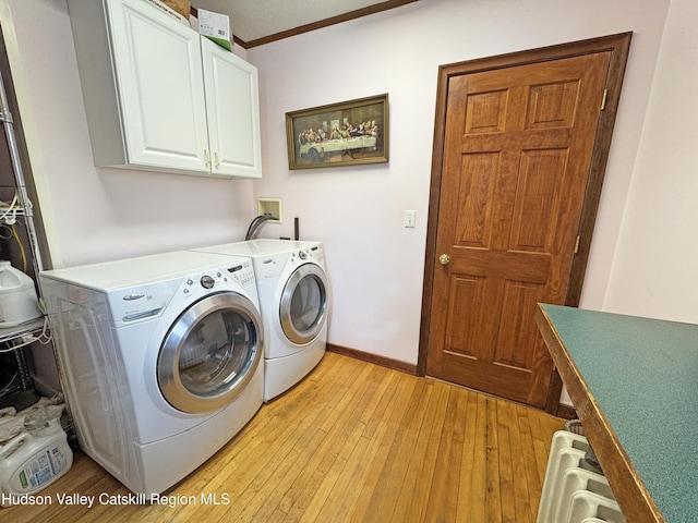 laundry area with separate washer and dryer, baseboards, ornamental molding, cabinet space, and light wood finished floors