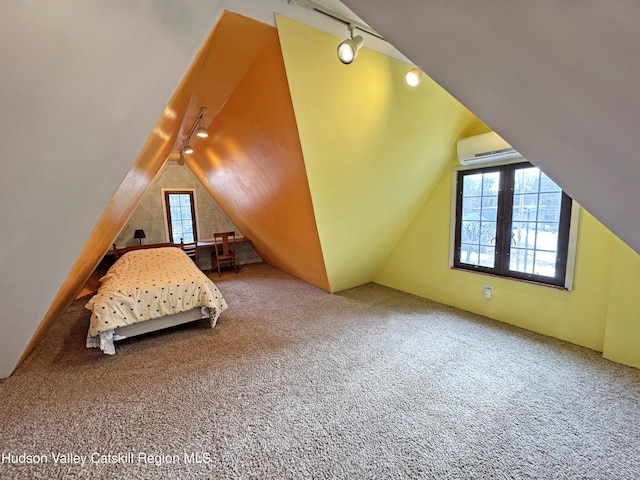 carpeted bedroom with multiple windows, vaulted ceiling, and track lighting