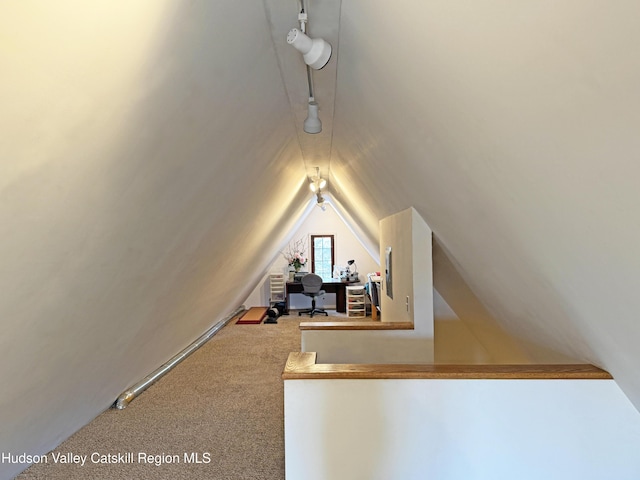 bonus room with vaulted ceiling and carpet floors