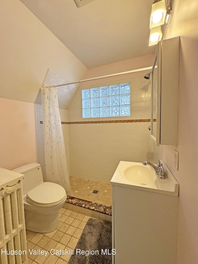 2 Malden Ave, Saugerties, NY 12477 - bathroom featuring vanity, toilet, tile patterned flooring, tiled shower, and lofted ceiling
