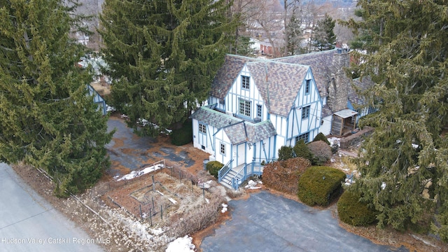 view from above of property with a tree filled landscape
