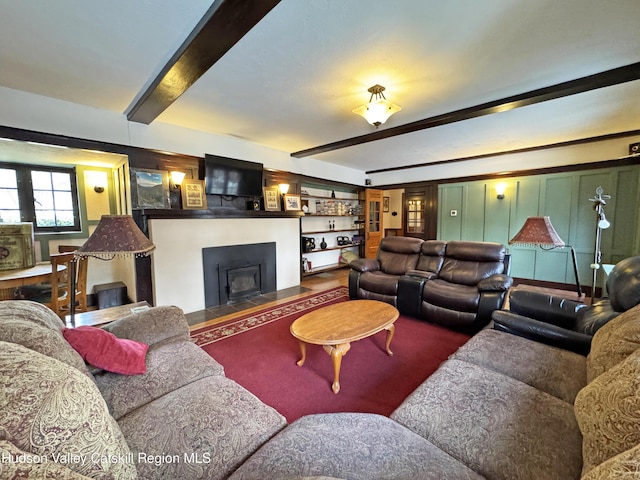 living area with beamed ceiling