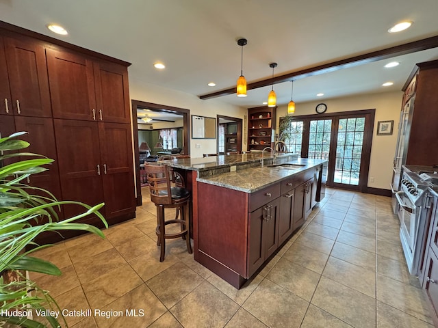 2 Malden Ave, Saugerties, NY 12477 - kitchen with a sink, dark stone counters, recessed lighting, plenty of natural light, and light tile patterned floors