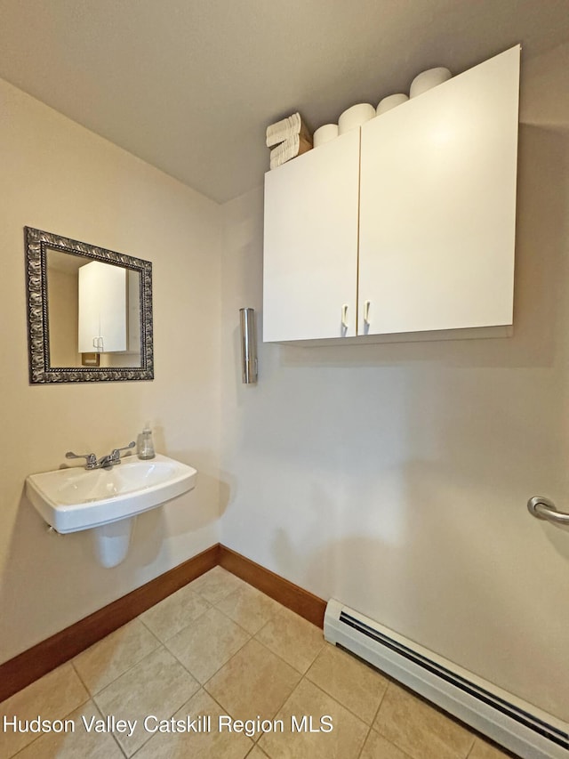2 Malden Ave, Saugerties, NY 12477 - bathroom with a baseboard radiator, baseboards, tile patterned flooring, and a sink