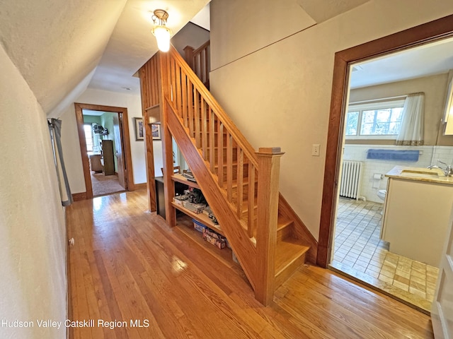 2 Malden Ave, Saugerties, NY 12477 - stairs featuring radiator heating unit, wood finished floors, vaulted ceiling, and baseboards